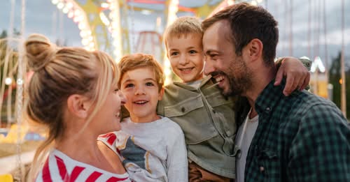 Photo of a happy family at the amusement park